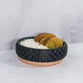 "Angled shot of BLOSSOM bowl planter with moss buns in a fitted insert, highlighting wood and carbon fibre design."